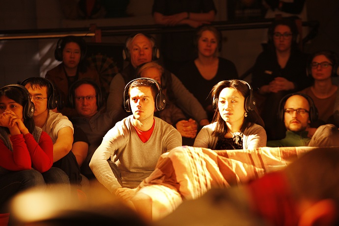 Audience members watch Silent Opera's technology-enhanced production of La bohème