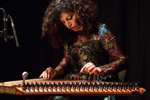 Picture of Maya Youssef playing the quanun