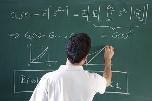 Picture of someone doing maths on a blackboard