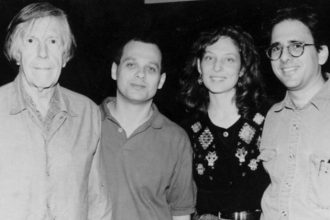 Picture of young Julia Wolfe with composer John Cage, David Lang, and Michael Gordon