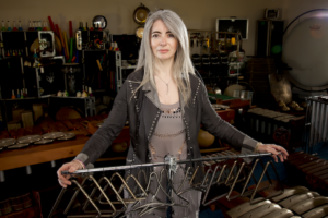 Picture of percussionist Dame Evelyn Glennie with racked triangles