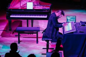 Picture of pianist Conrad Tao playing the lumatone