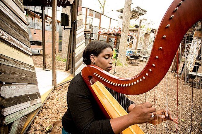 Picture of harpist Cassie Watson Francillon at Music Box Village in New Orleans